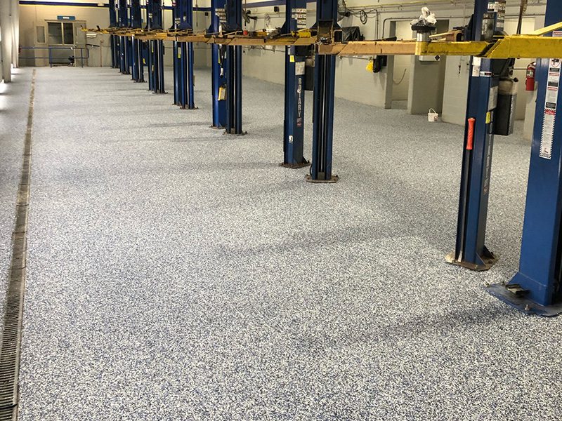 commercial epoxy flake floor installation in auto shop by young flooring